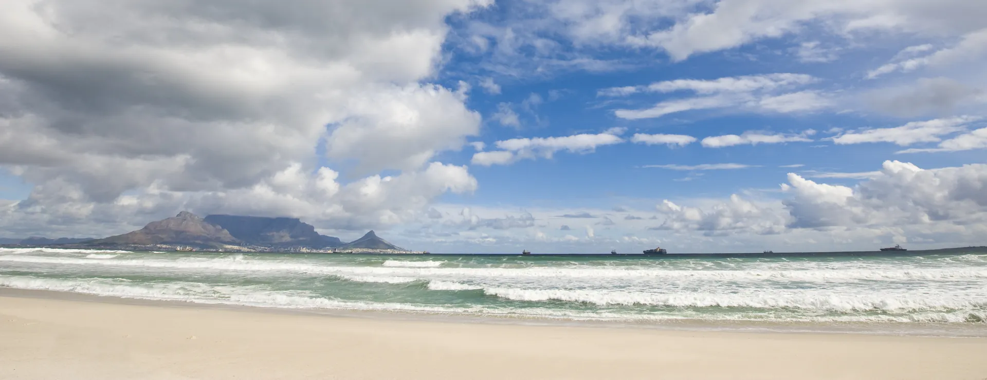 Robben Island and Table Mountain on the horizon from Bloubergstrand beach