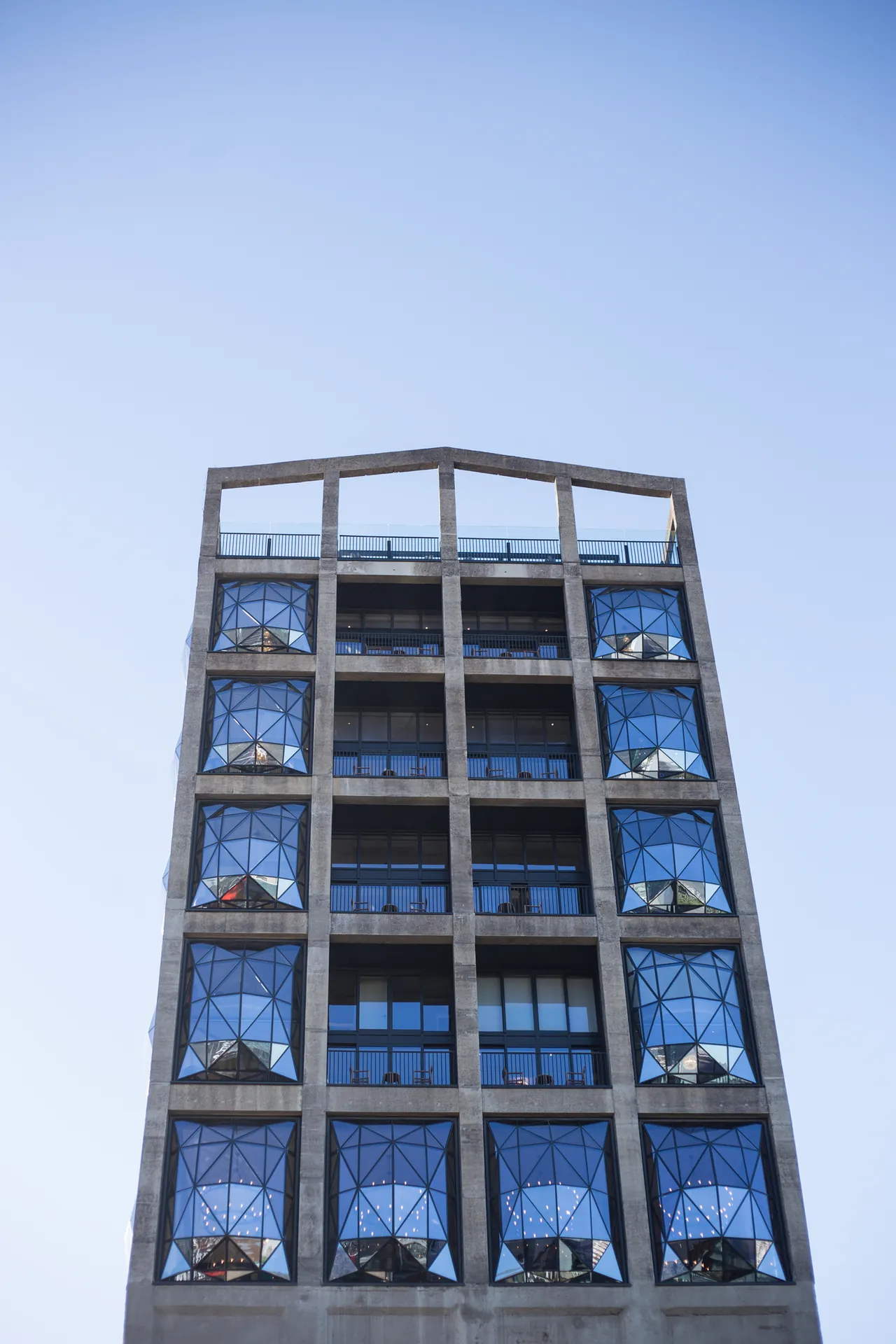 The pillowed glass windows of The Silo Hotel against the sky