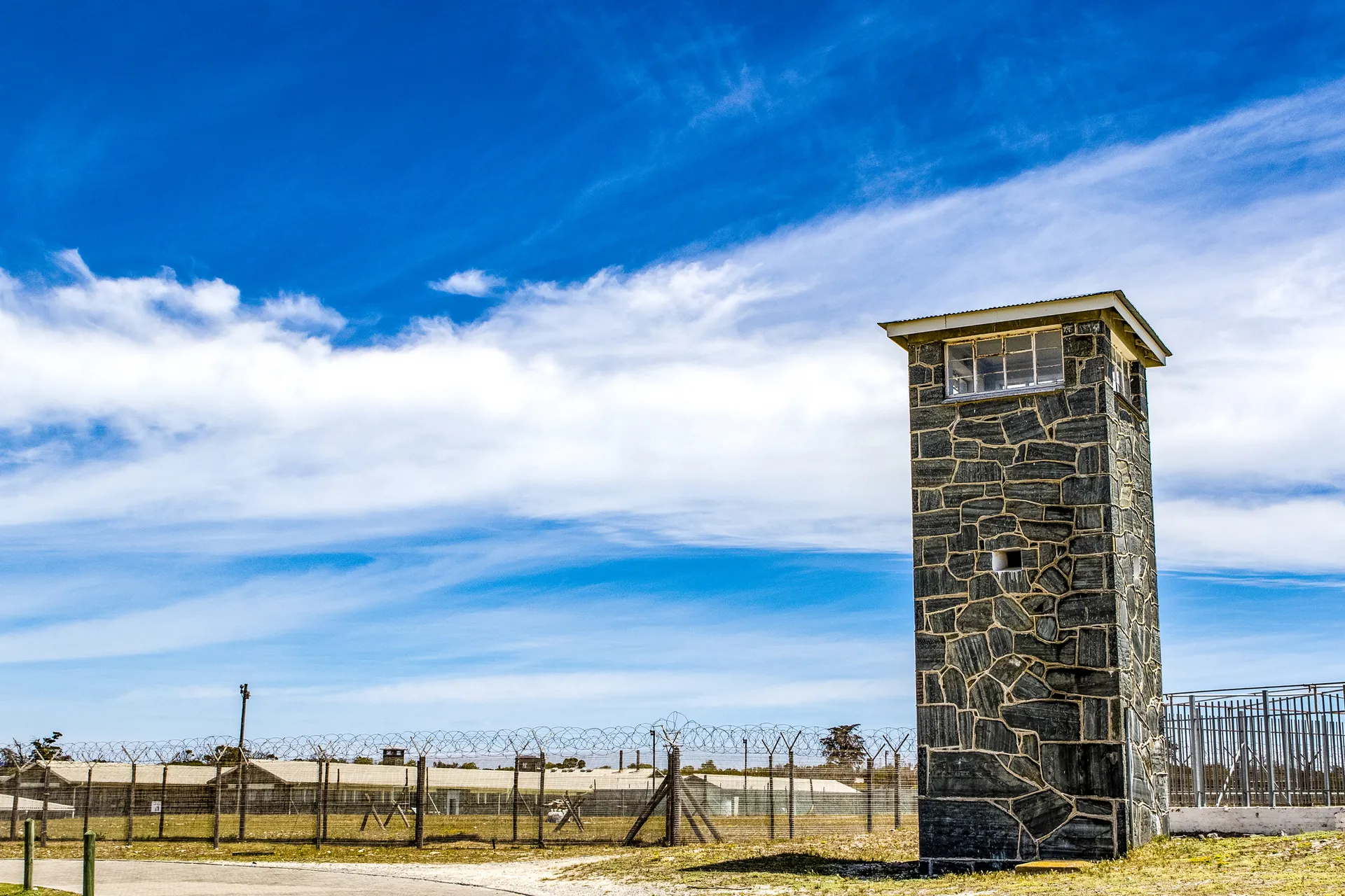A stone guard tower beside the prison fence on Robben Island